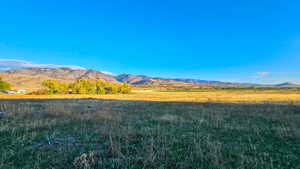 View of mountain backdrop with rural landscape