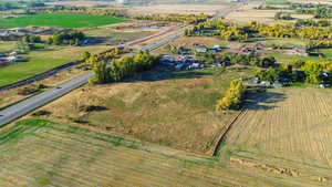 Aerial view of property and surrounding area with rural landscape and rows of crops