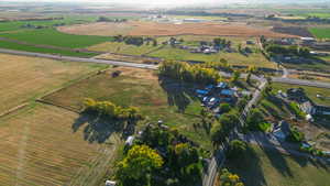 Aerial view of property and surrounding area featuring rural landscape and farmland
