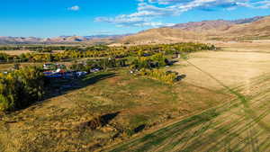 Aerial view of property's location with a mountainous background and rural landscape