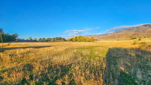 View of mountain backdrop featuring rural landscape