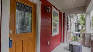 Doorway to property with covered porch