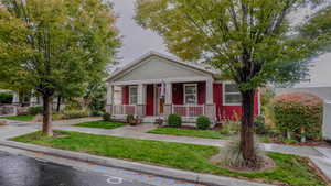 Craftsman house with a front yard and covered porch