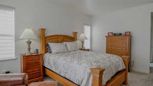 Carpeted bedroom with baseboards