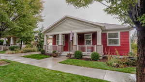 Craftsman inspired home featuring a porch and a front lawn