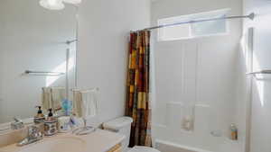 Full bathroom with shower / bath combination with curtain and vanity