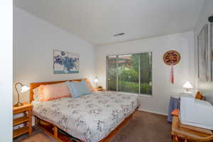 Bedroom featuring carpet flooring and baseboards