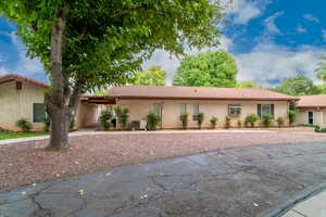 Single story home with a tile roof and stucco siding