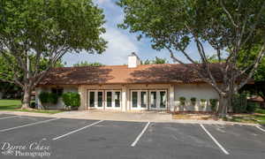 View of property featuring uncovered parking