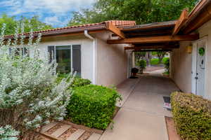 View of side of property with a tiled roof and stucco siding