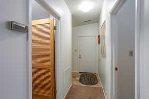 Corridor featuring carpet and lofted ceiling