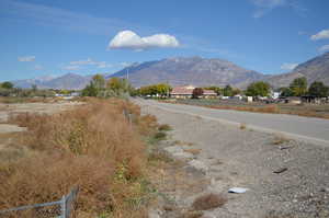 View of asphalt street featuring a mountain view