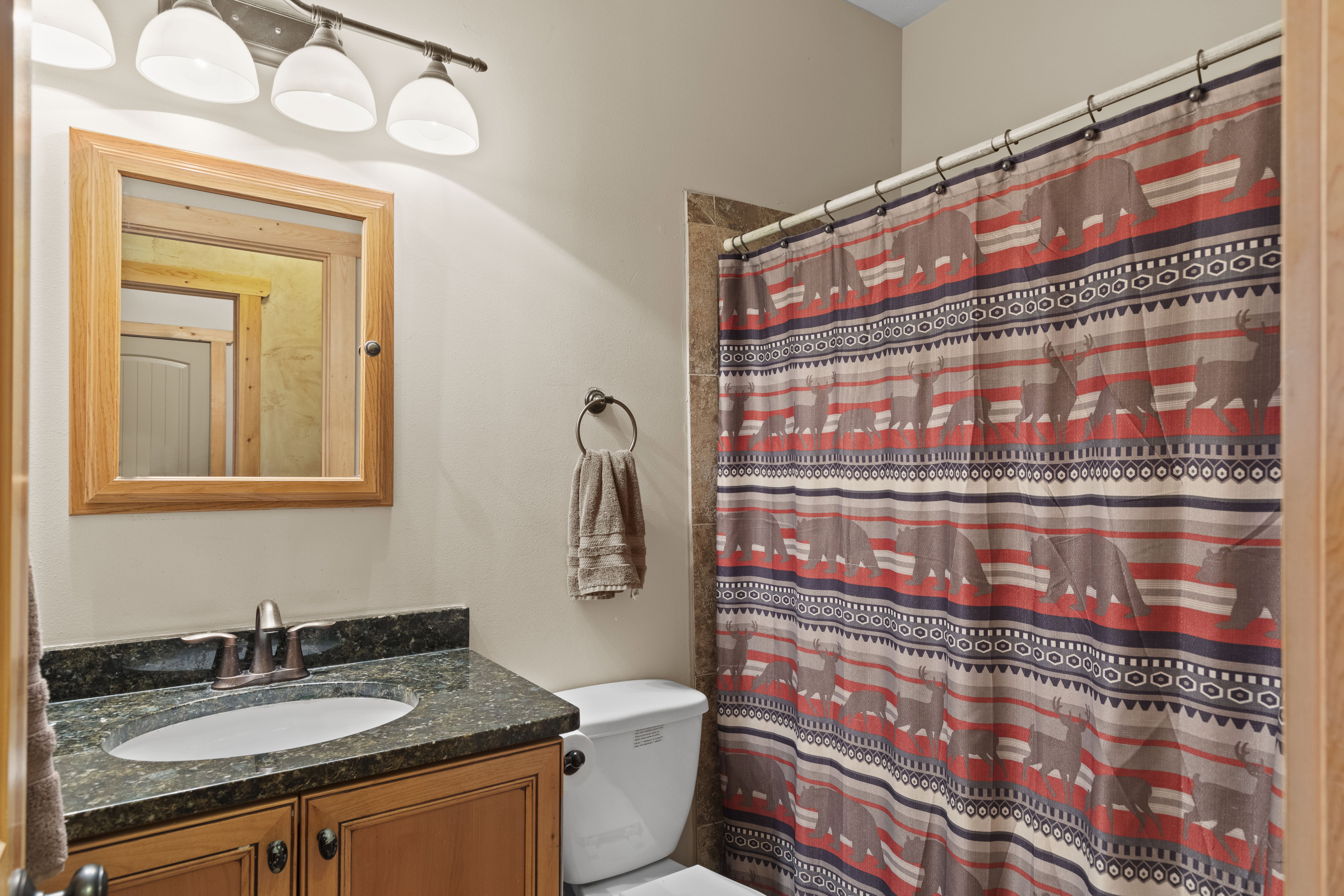 Full bathroom with vanity and curtained shower