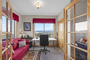 Carpeted office featuring a mountain view and french doors