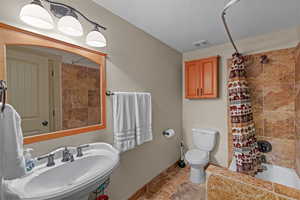 Bathroom featuring shower / tub combo and toilet