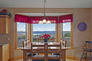 Dining room with a mountain view and a chandelier