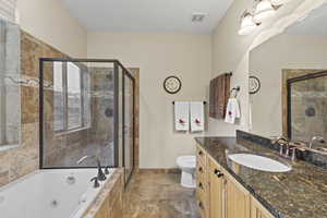 Full bathroom with vanity, a whirlpool tub, and a stall shower