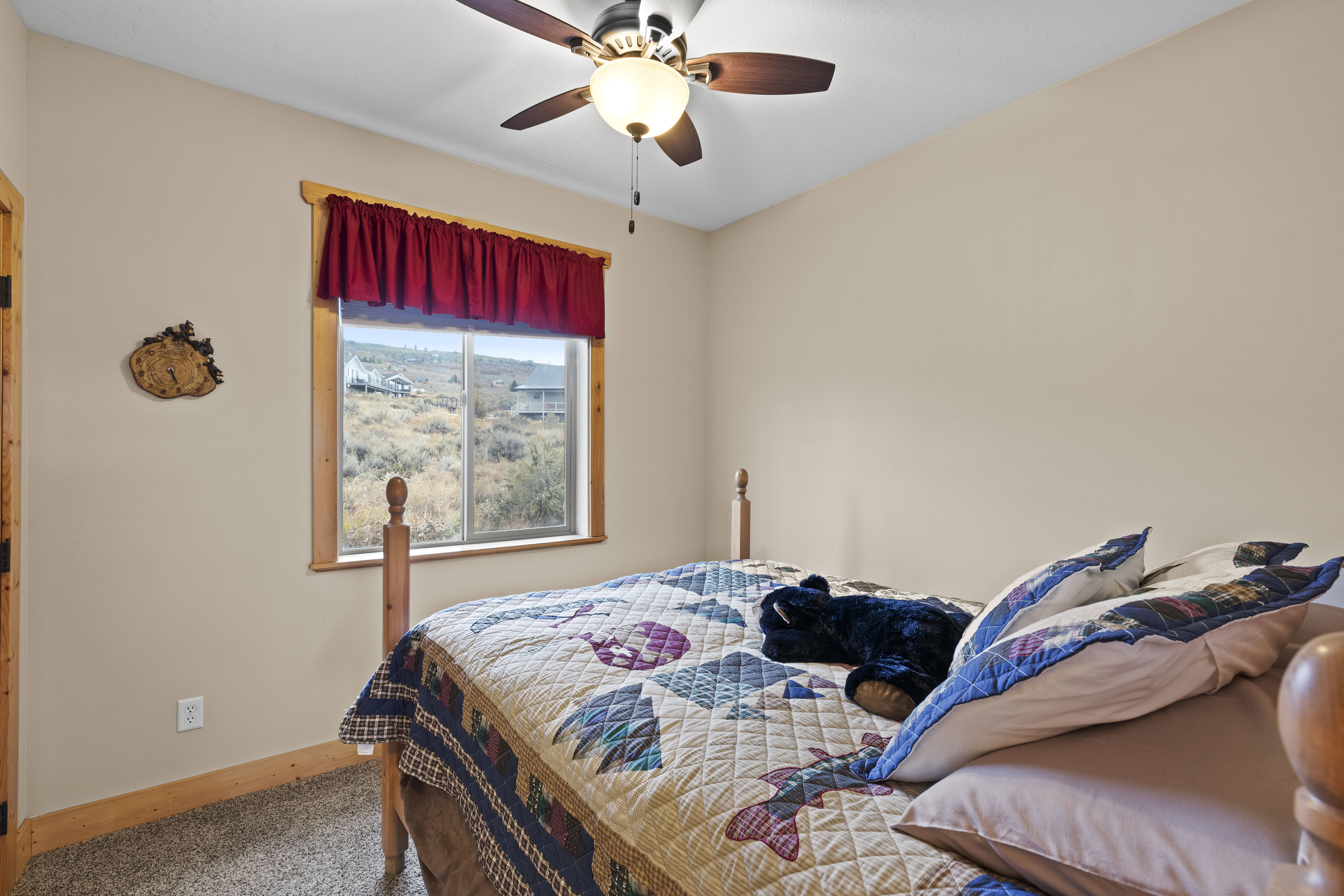 Bedroom featuring a ceiling fan and carpet floors
