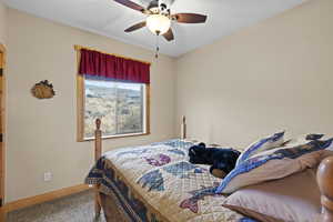 Bedroom featuring a ceiling fan and carpet floors
