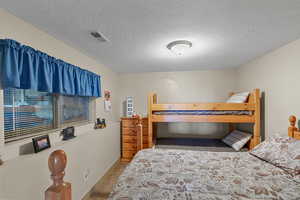 Bedroom with carpet floors and a textured ceiling