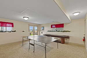 Recreation room featuring a textured ceiling and french doors