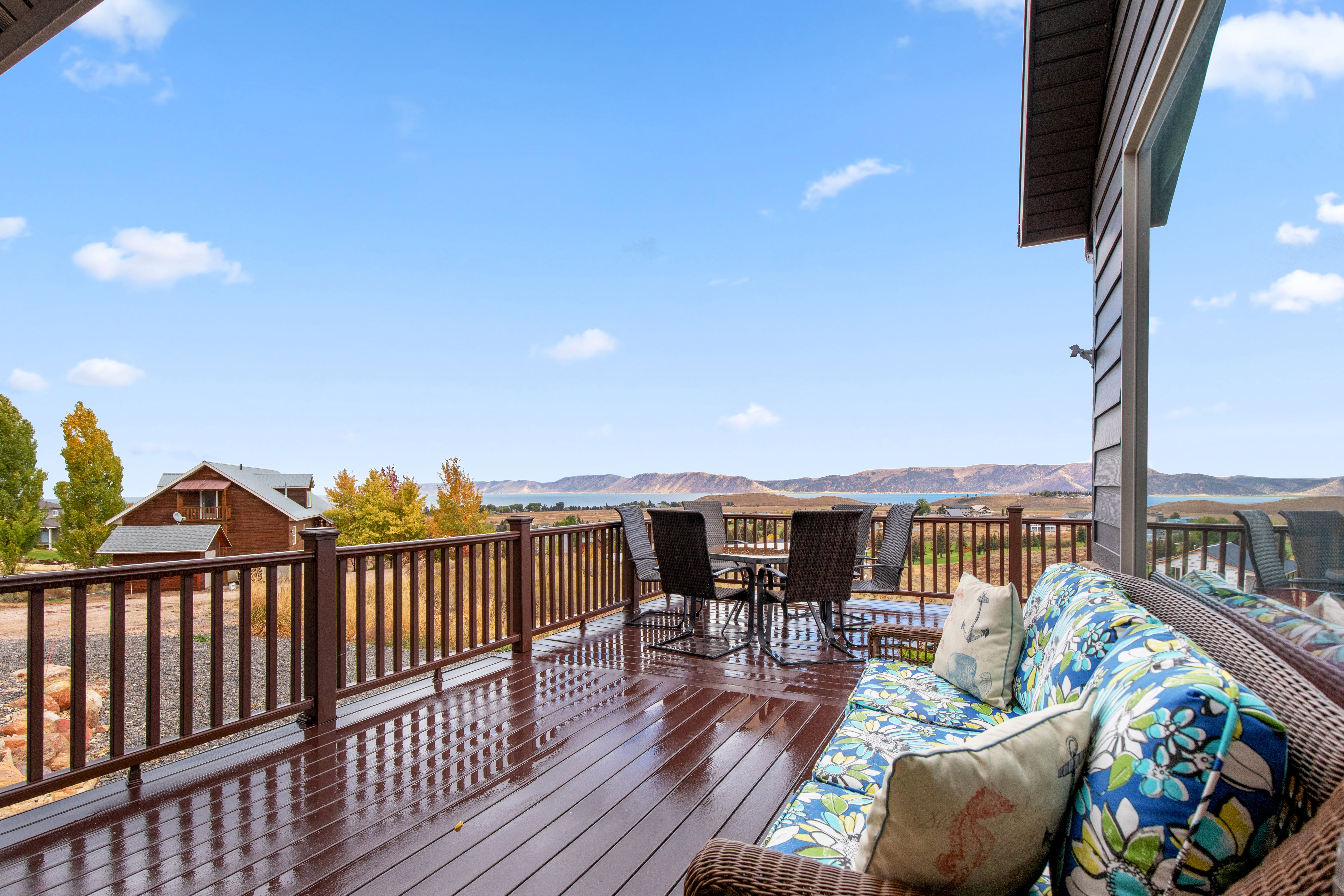 Wooden deck with a mountain view and outdoor dining area