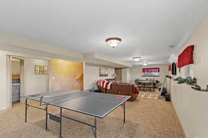 Playroom with light carpet and a textured ceiling