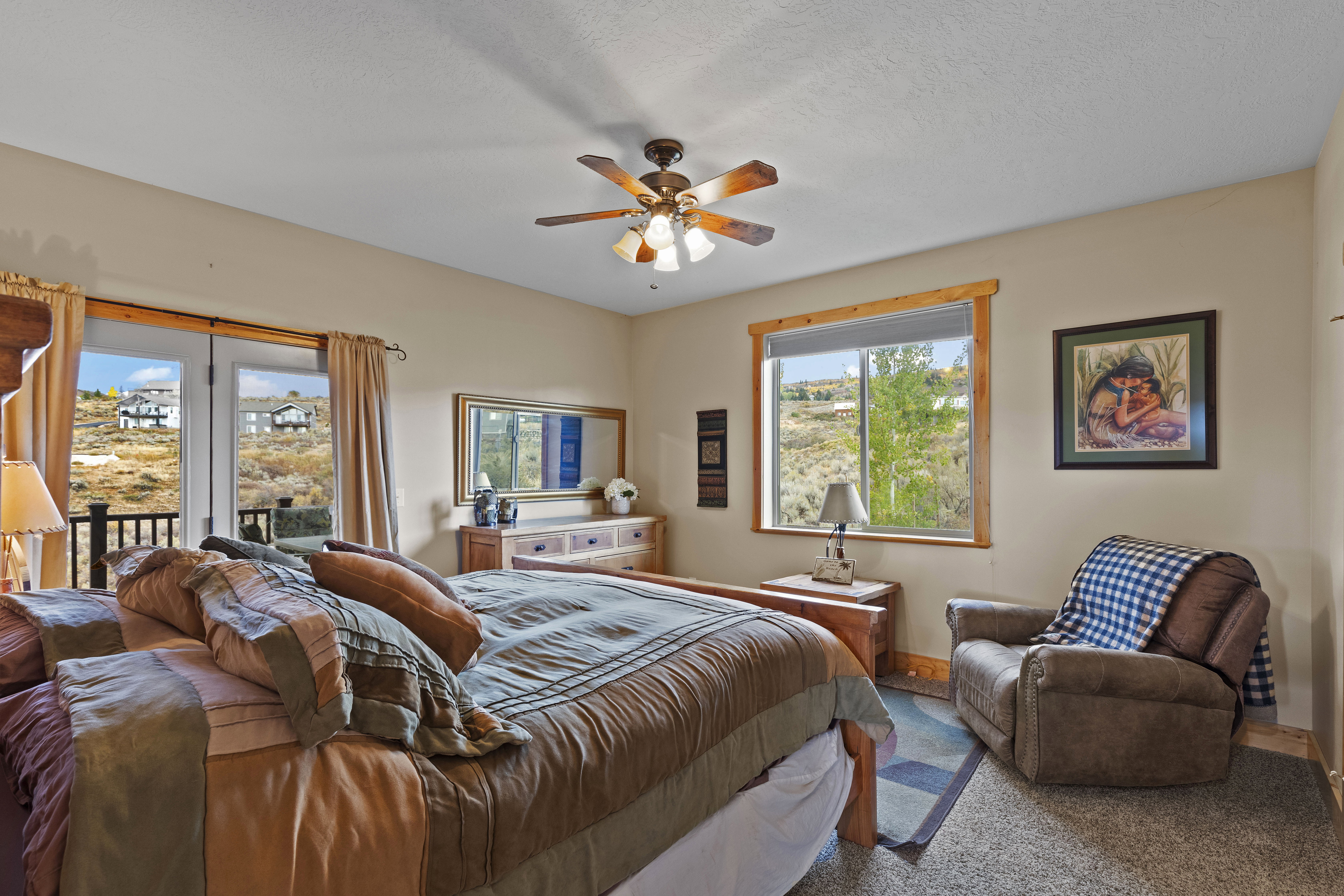 Bedroom featuring access to exterior, a ceiling fan, and a textured ceiling