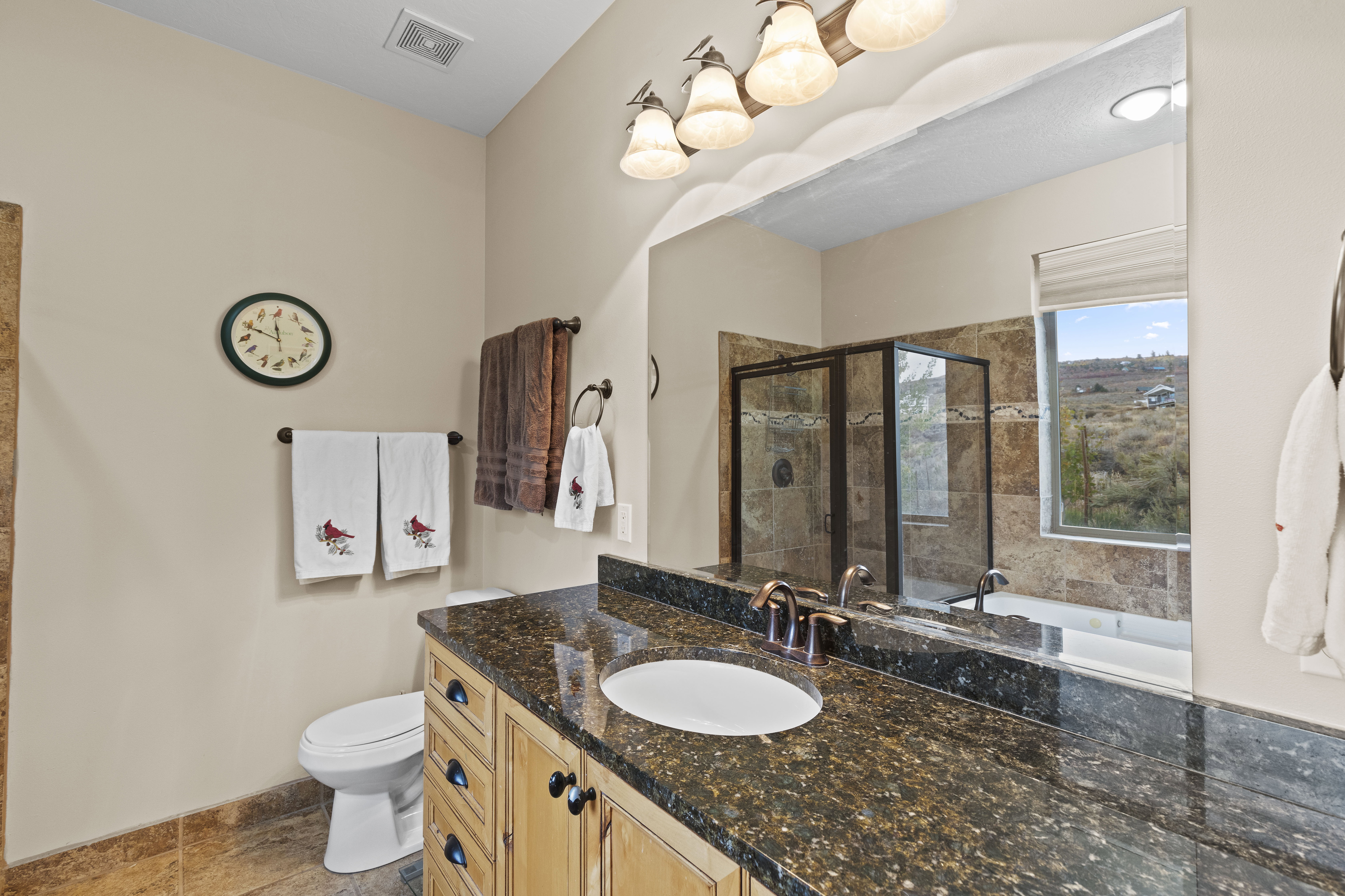 Full bath featuring vanity, a stall shower, and a garden tub