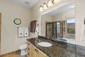 Full bath featuring vanity, a stall shower, and a garden tub