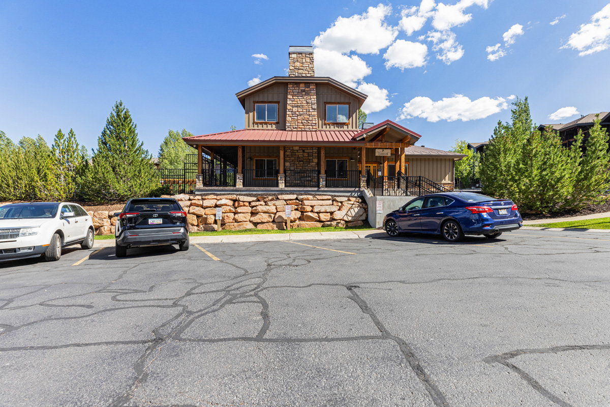 View of building exterior with uncovered parking