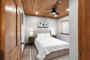 Bedroom featuring wood finished floors, wood ceiling, recessed lighting, and ceiling fan