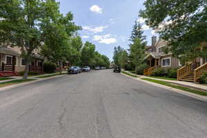 View of asphalt road with sidewalks, curbs, and a residential view