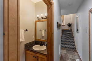 Bathroom featuring stone tile floors and vanity