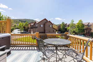 Wooden deck with a residential view and outdoor dining area