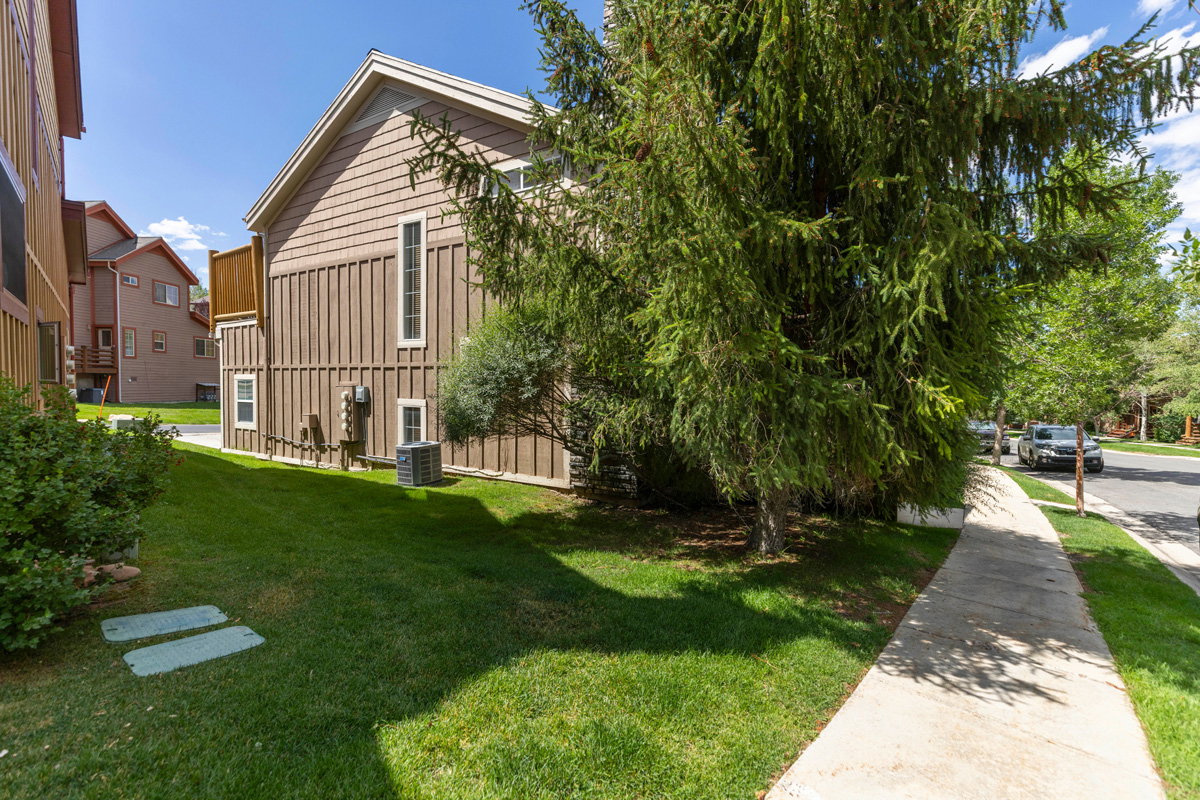 View of home's exterior featuring a yard and board and batten siding