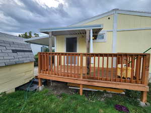 Rear view of property featuring a deck
