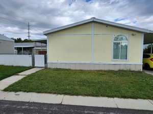 View of side of home with a gate