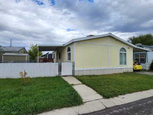 View of front facade with a gate and a fenced front yard