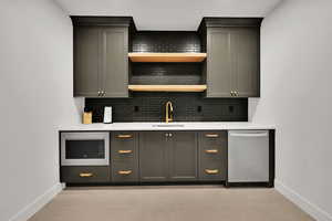 Bar area with tasteful backsplash, appliances with stainless steel finishes, light stone counters, open shelves, and light tile patterned flooring