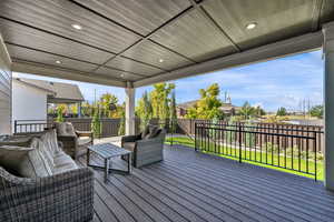 Deck with an outdoor hangout area, a fenced backyard, and a residential view