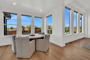 Sunroom featuring wood finished floors and recessed lighting