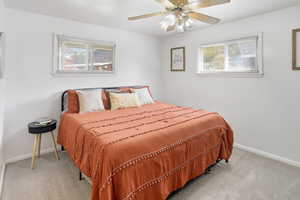 Bedroom featuring light carpet and ceiling fan