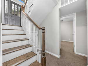 Stairway featuring carpet flooring and baseboards