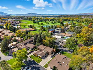 Aerial view of residential area featuring a water and mountain view and a golf club