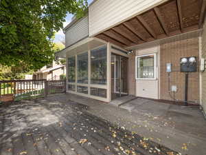 Wooden terrace featuring a sunroom