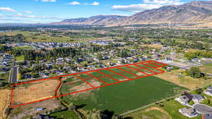 Aerial view of residential area featuring mountains and property parcel outlined