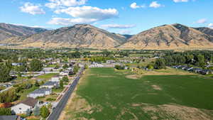 Aerial view of property's location featuring nearby suburban area and a mountain backdrop