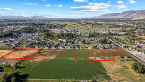 Aerial overview of property's location featuring a mountain backdrop and property parcel outlined