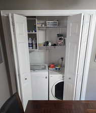 Laundry room with washer and clothes dryer